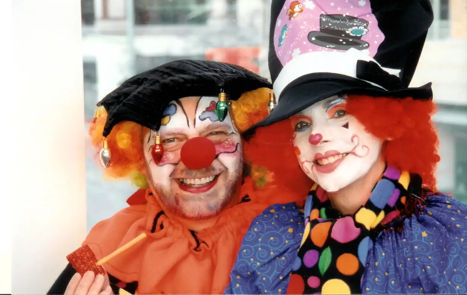 Clowns in colorful costumes and makeup smiling at The Cultural Trust event.