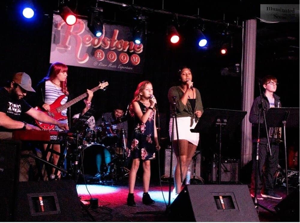 Young musicians performing live on stage at The Cultural Trust music event.