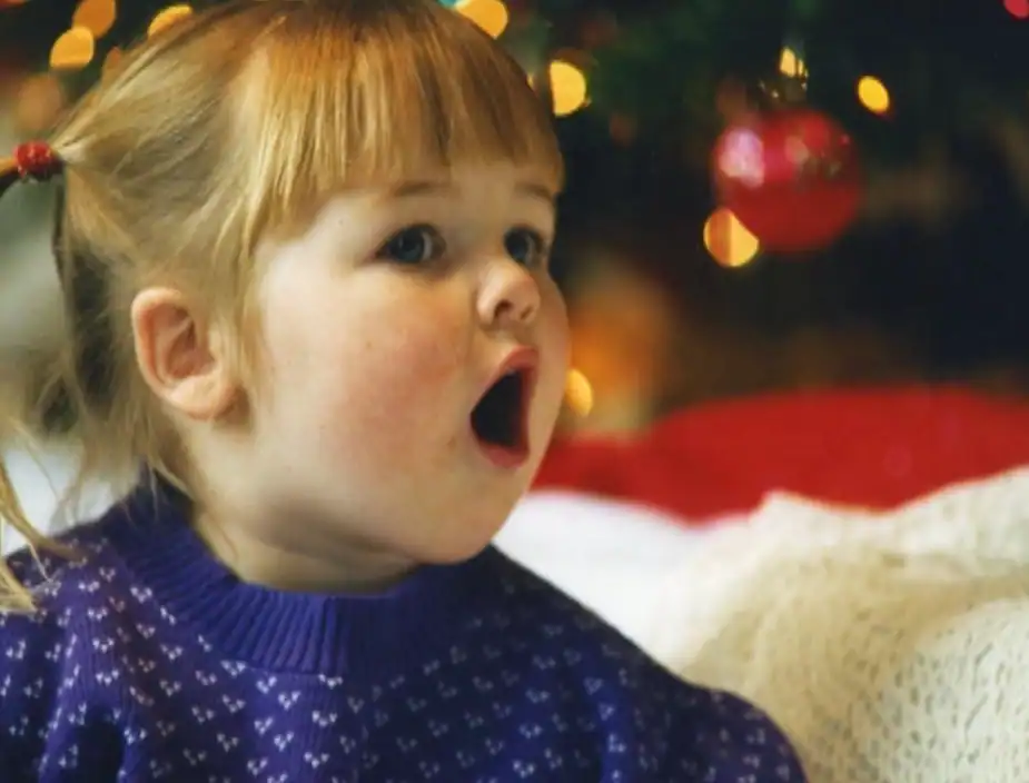 Child's joyful expression during holiday celebration.