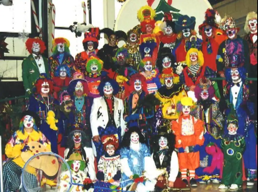 Colorful clown performers at The Cultural Trust event in vibrant costumes and makeup.