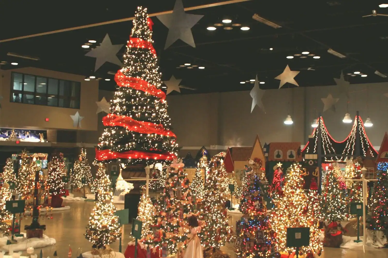 Christmas tree decorated with red ribbons and lights at The Cultural Trust holiday exhibit.