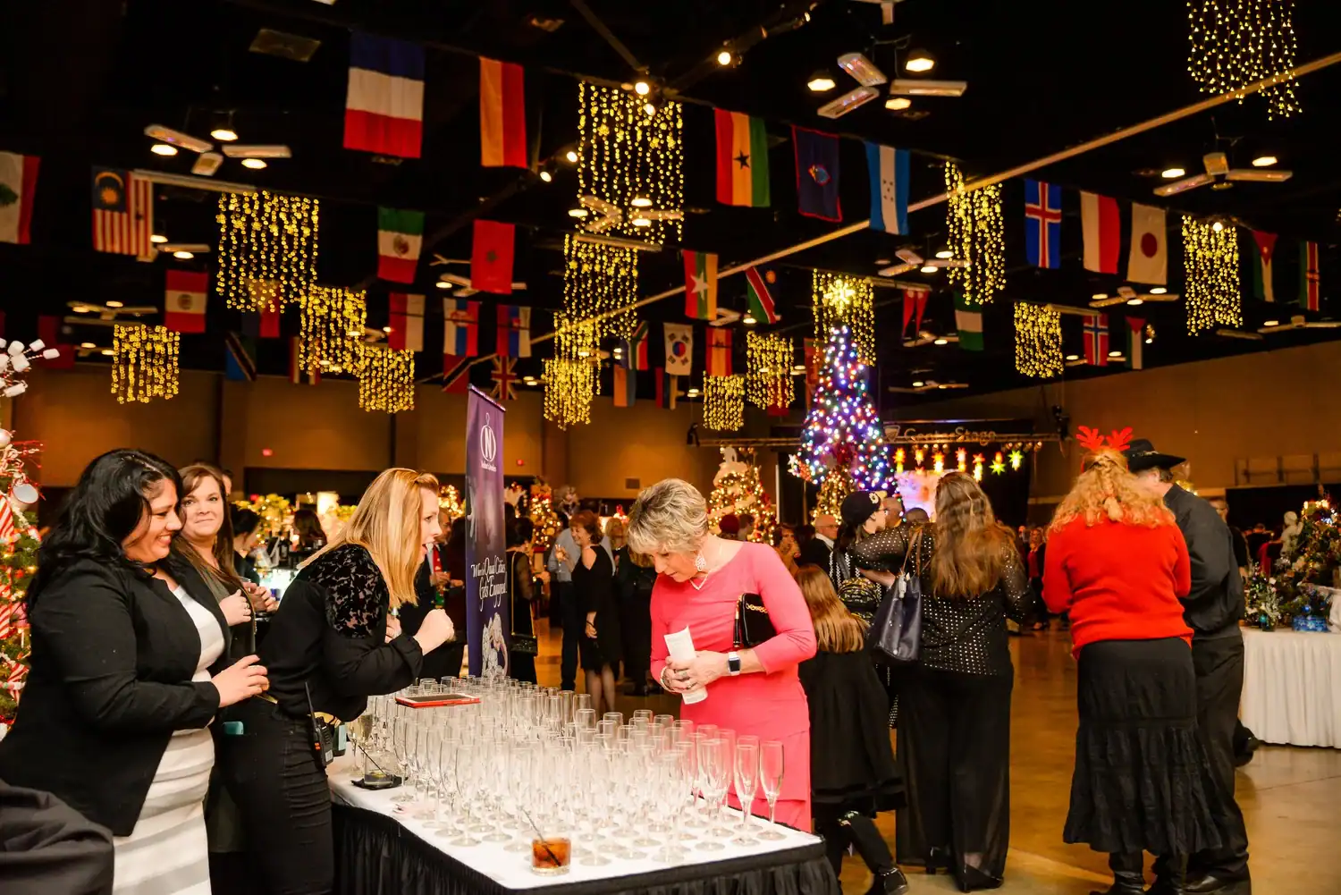 International flags hanging at the Cultural Trust event with festive decorations.