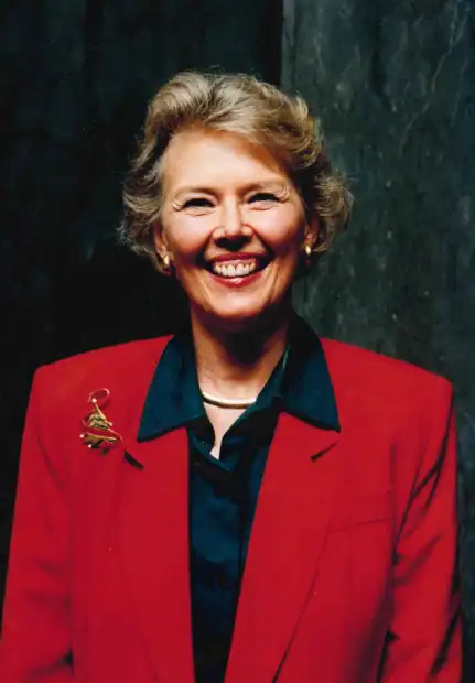 Woman smiling in red blazer at The Cultural Trust event.
