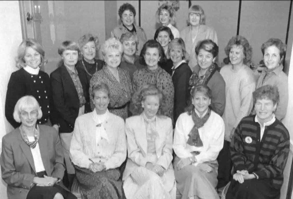 Group of diverse women and men gathered for a cultural or community event.