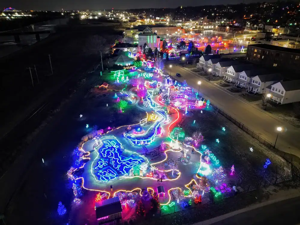 Brightly lit outdoor art installation with colorful neon lights and illuminated pathways at The Cult.