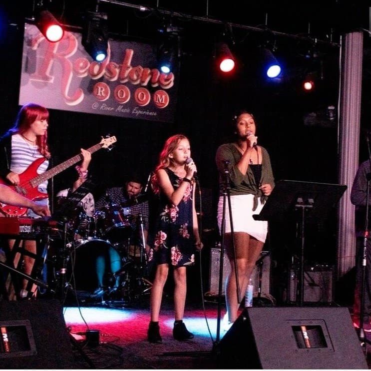 Young musicians performing live on stage at The Cultural Trust music event.