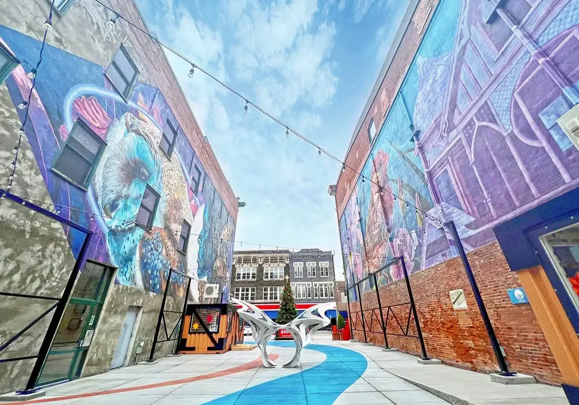 Colorful mural artwork on brick walls at The Cultural Trust outdoor space.