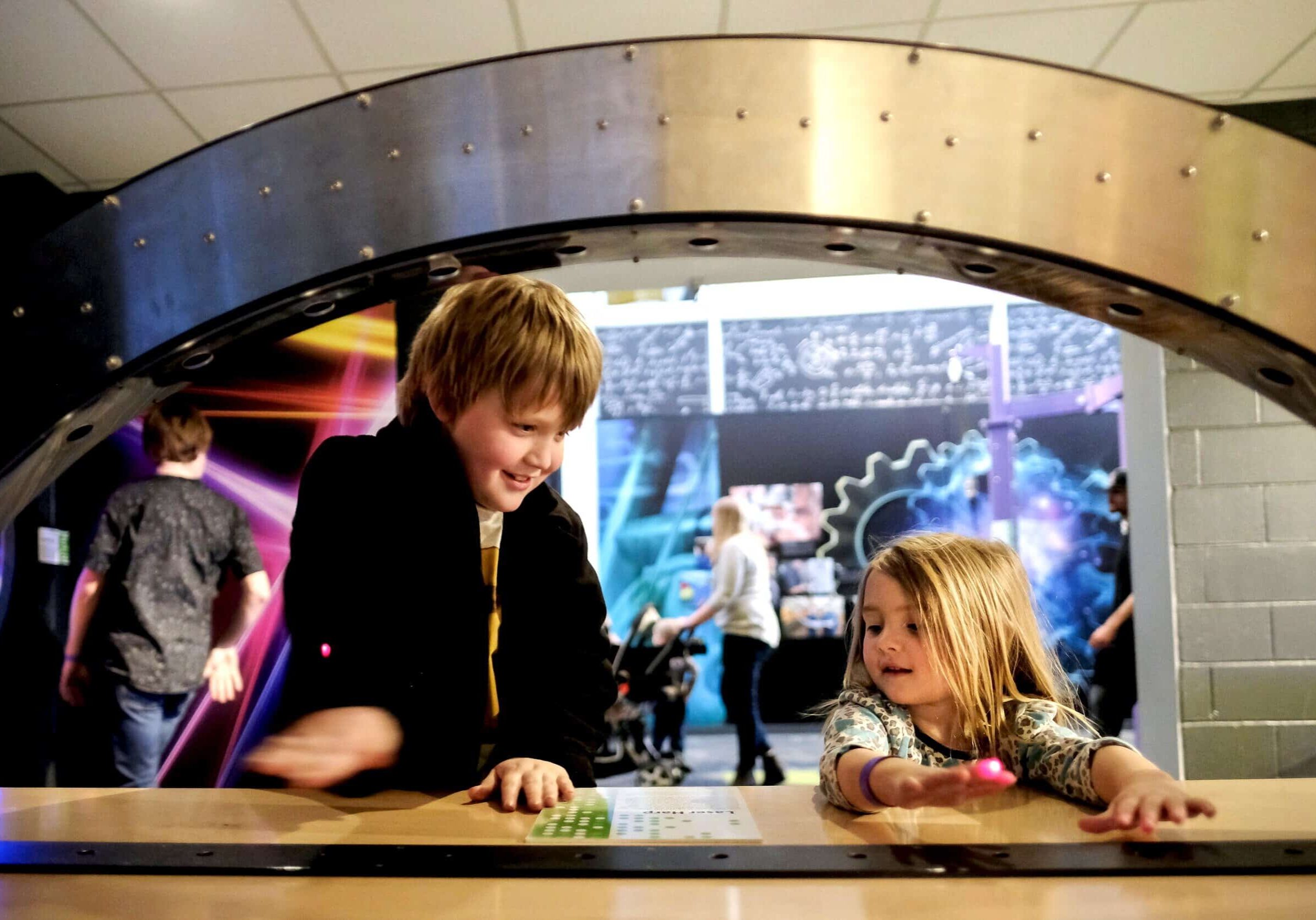 Children engaging with a hands-on science exhibit at The Cultural Trust.