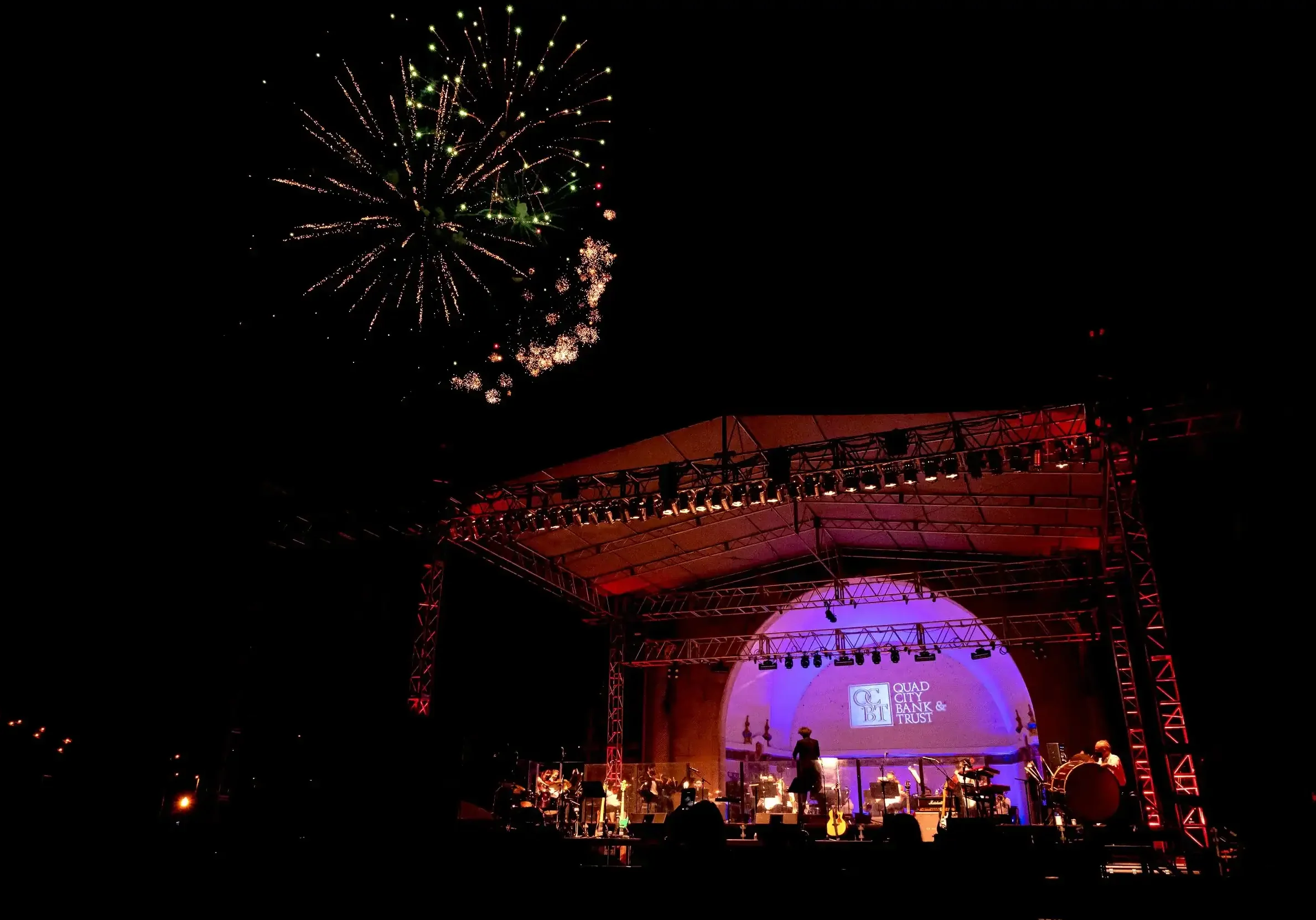 Fireworks display over outdoor stage at The Cultural Trust event at night.